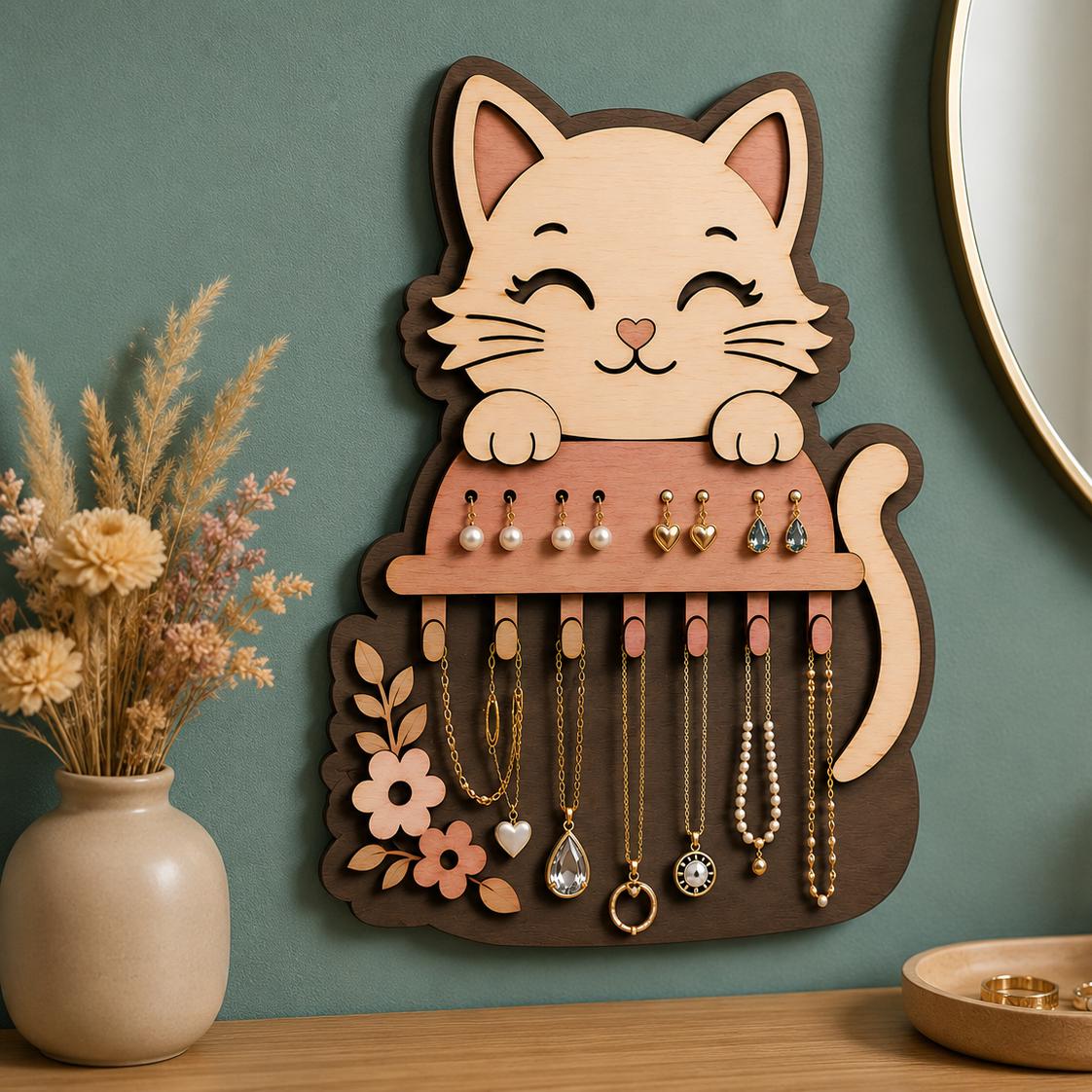 Decorative cat jewelry organizer SVG on a green accent wall with hanging necklaces and earrings, showcasing layered laser cut wood artwork and functional storage.