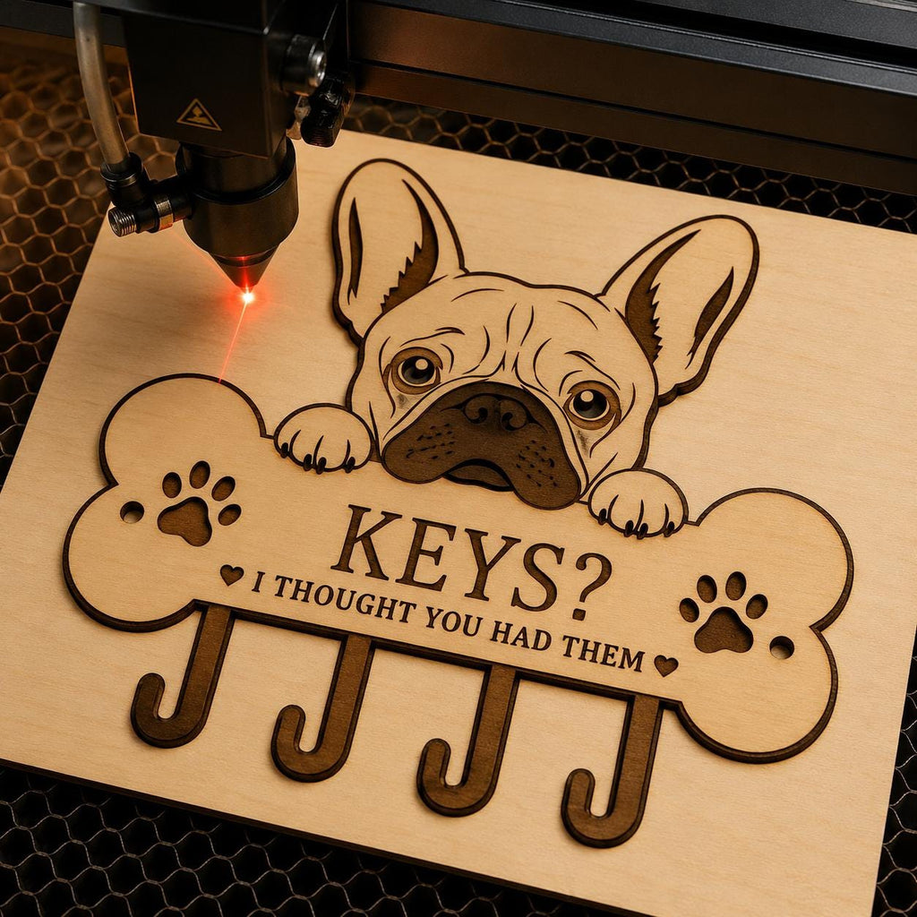 French Bulldog key holder design being engraved on a laser cutting machine, showcasing clean cut lines and layered wood details for DIY crafting.