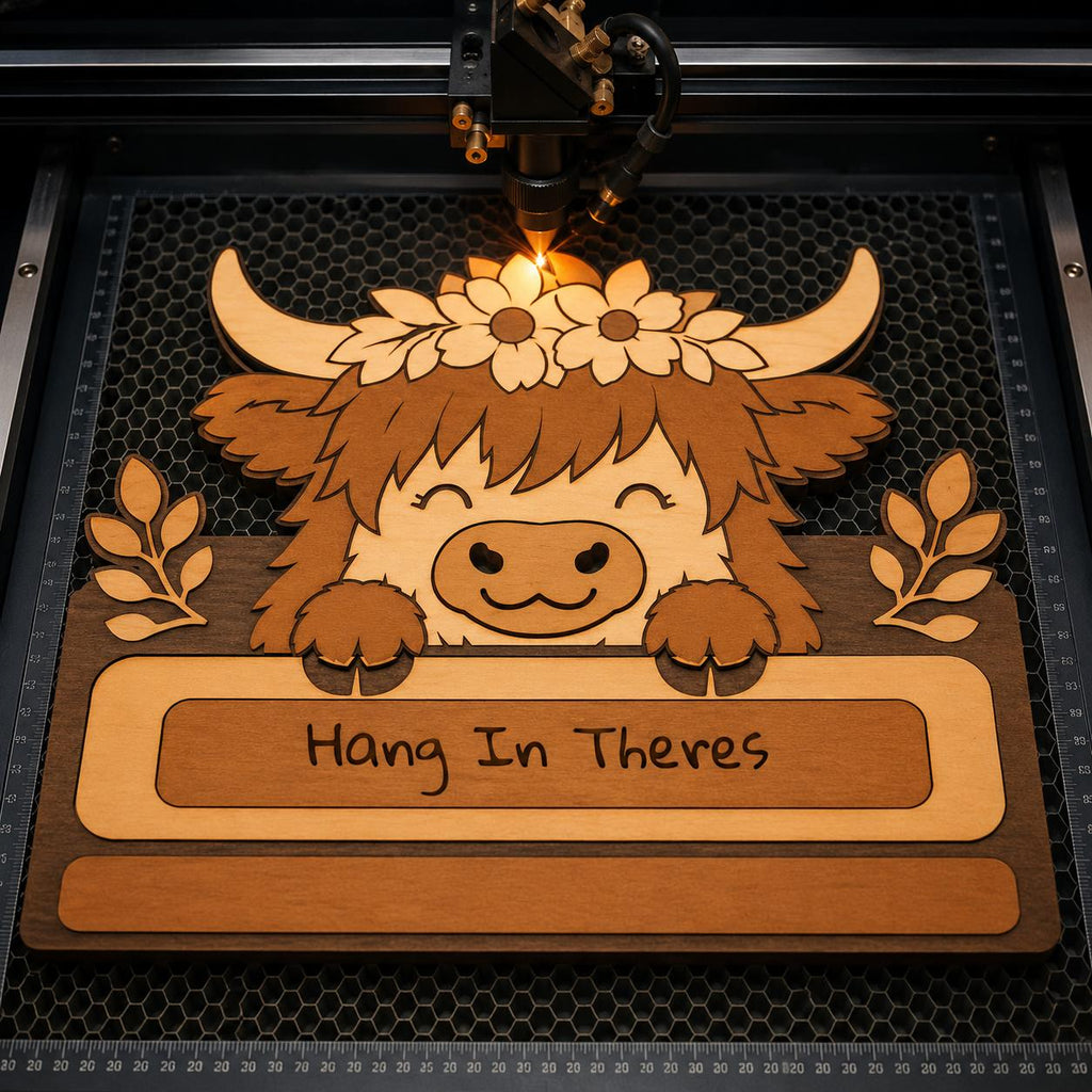 Laser cutting machine engraving a Highland Cow towel holder SVG file with floral crown details for Glowforge, CNC, and laser cutting projects.