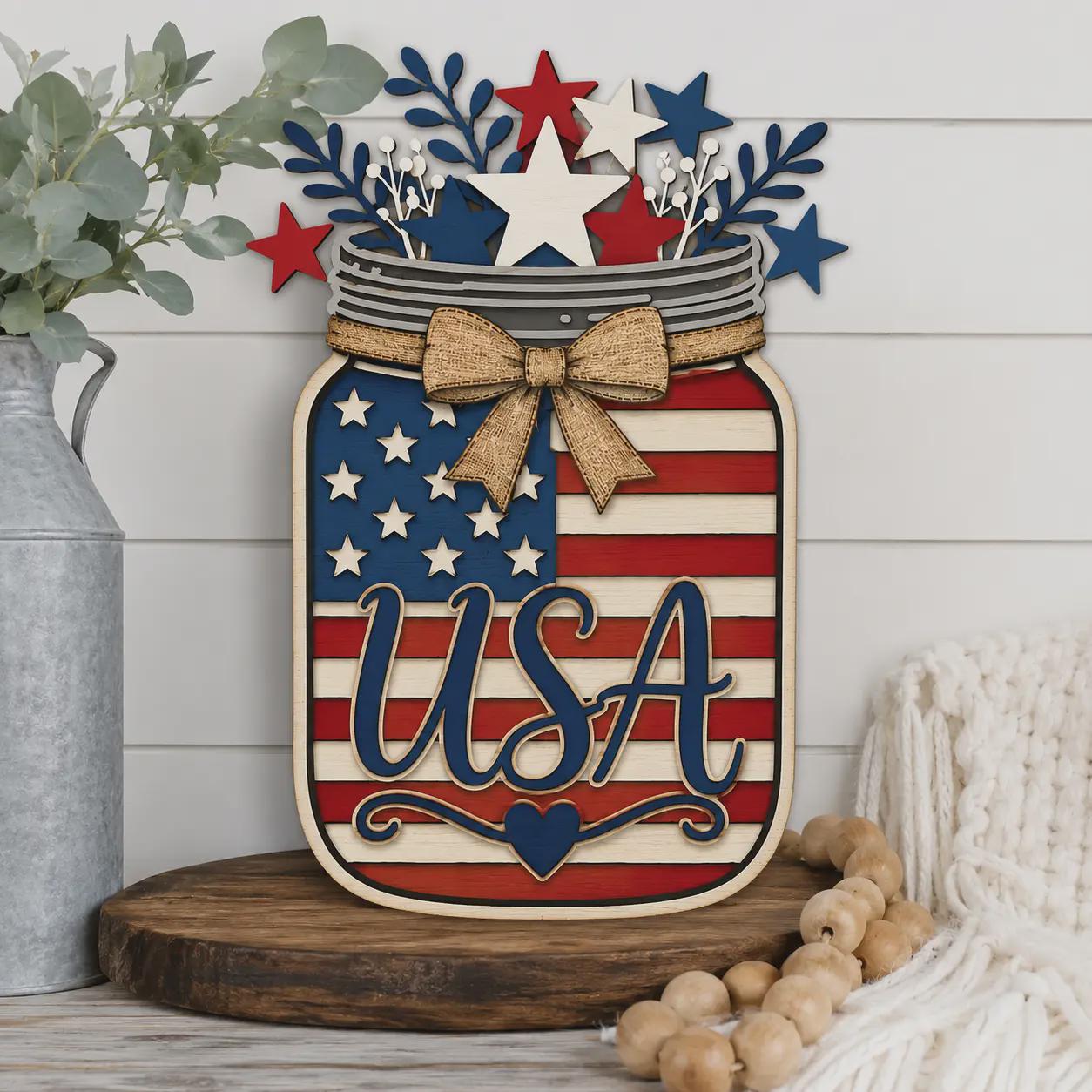 Patriotic USA Mason Jar wooden sign displayed on a farmhouse shelf, layered American flag laser cut design with stars, bow, and Independence Day home decor styling.