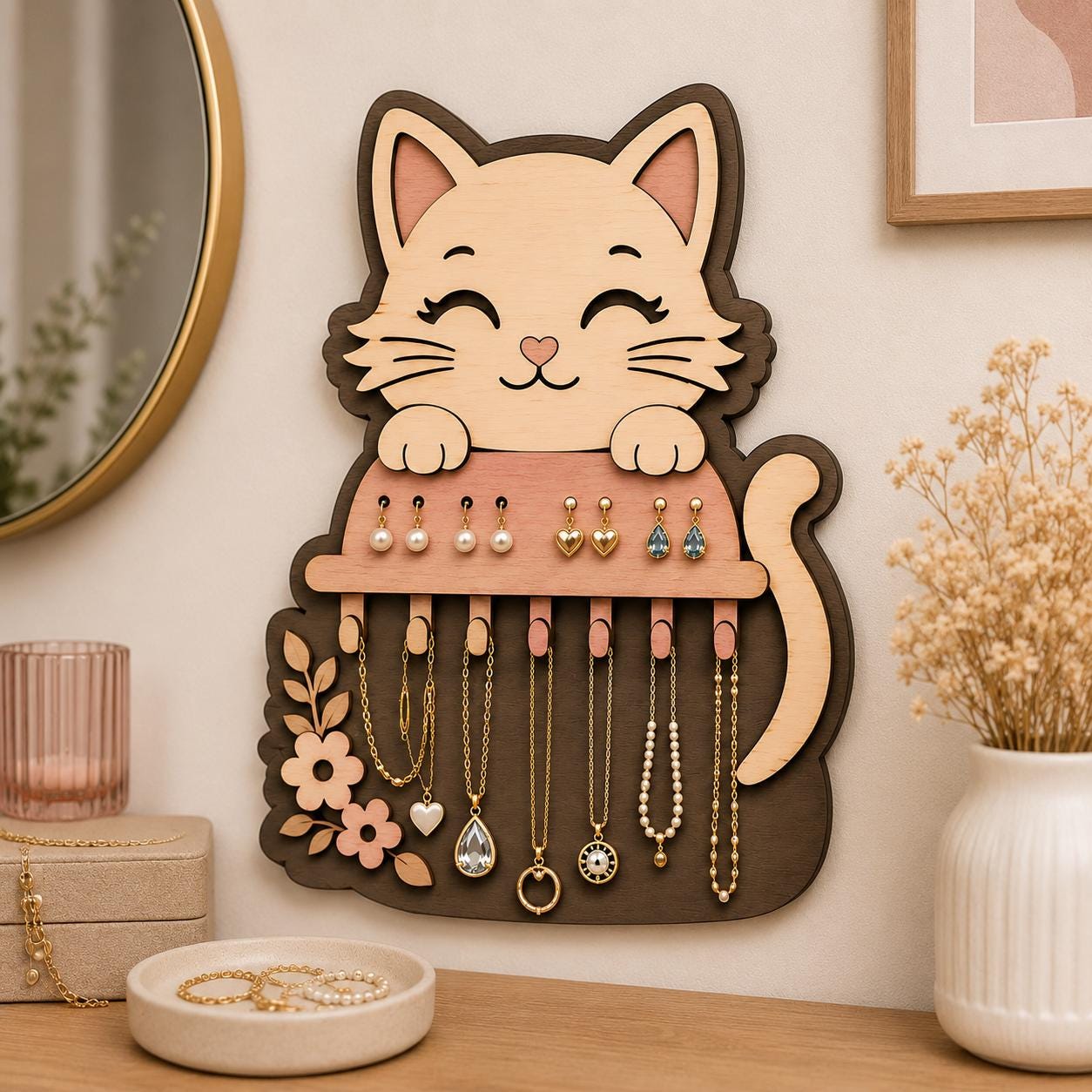Layered cat jewelry holder mounted on a wall displaying earrings and necklaces, featuring floral details, laser cut wood design, and elegant jewelry organization.
